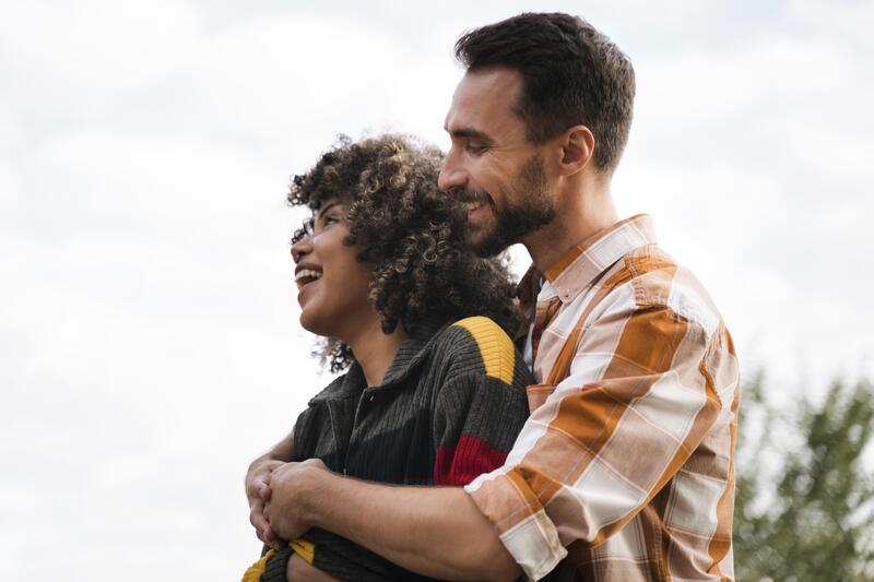 Couple smiling while looking at the horizon